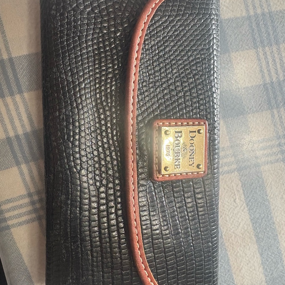 Dooney & Bourke Black Textured Wallet with Brown Trim.